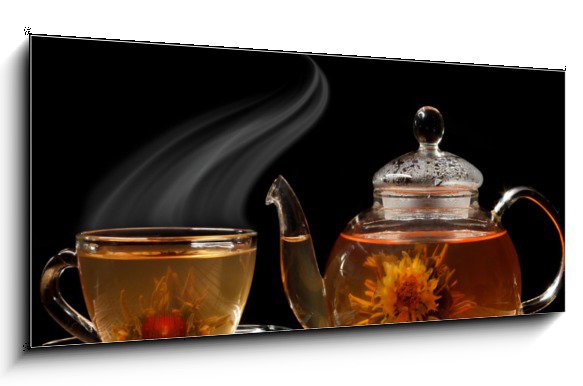 Glass teapot and a cup of green tea on a black background