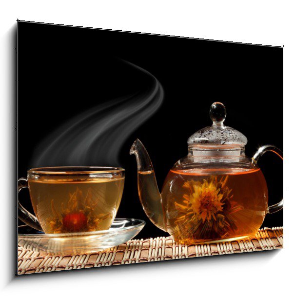 Glass teapot and a cup of green tea on a black background