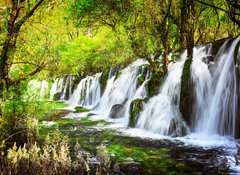 Samolepka fólie 100 x 73, 107722539 - Scenic waterfall with crystal clear water among green forest - Scénický vodopád s křišťálově čistou vodou mezi zelenými lesy