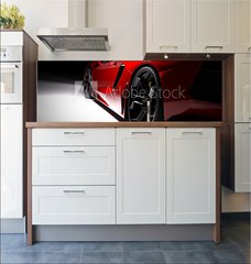 Fototapeta do kuchyn flie 180 x 60  Red fast sports car in spotlight, black background. Shiny, new, luxurious., 180 x 60 cm
