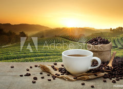 Samolepka flie 100 x 73, 125680313 - Hot Coffee cup with Coffee beans on the wooden table and the pla - Hork lek kvy s kvov zrna na devn stl a pla