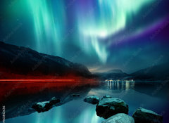 Fototapeta100 x 73  A large Northern Lights (aurora borealis) display glowing over a mountain pass and reflected on a lake at night. Photo composition., 100 x 73 cm