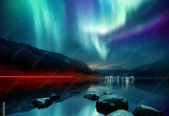 Fototapeta pltno 174 x 120, 163852636 - A large Northern Lights (aurora borealis) display glowing over a mountain pass and reflected on a lake at night. Photo composition.