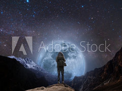 Samolepka flie 270 x 200, 205708981 - a man with backpack standing on mountain peak at night, and silhouette mountain with bright full moon and sky full of stars - mu s batohem stojc na vrcholu hory v noci a silueta hory s jasnm plkem a oblohou plnou hvzd