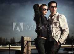 Fototapeta100 x 73  Attractive young couple wearing sunglasses, 100 x 73 cm