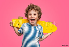 Fototapeta pltno 174 x 120, 245786759 - Happy curly boy laughing and holding skateboard
