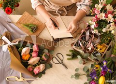 Fototapeta papr 160 x 116, 266667837 - Florist writing in notebook at table