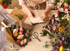 Fototapeta papr 254 x 184, 266667837 - Florist writing in notebook at table