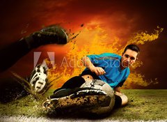 Fototapeta100 x 73  Football player in fires flame on the outdoors field, 100 x 73 cm