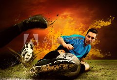Fototapeta174 x 120  Football player in fires flame on the outdoors field, 174 x 120 cm