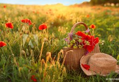 Fototapeta pltno 174 x 120, 276027409 - Basket of wildflowers with straw hat in sunlit poppy field