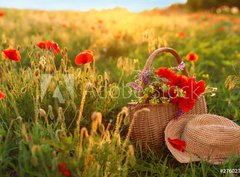 Fototapeta pltno 330 x 244, 276027409 - Basket of wildflowers with straw hat in sunlit poppy field