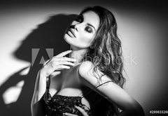 Fototapeta papr 184 x 128, 289833288 - Sexy Young Woman black and white portrait. Seductive young woman in lingerie in darkness. Glamour lady with long hair posing in spotlight. Gorgeous seductive model girl with long hair b