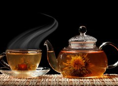 Fototapeta100 x 73  Glass teapot and a cup of green tea on a black background, 100 x 73 cm