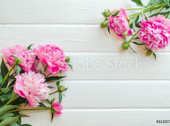 Fototapeta pltno 330 x 244, 313371368 - Pink peony flowers on white wooden table. womans day or wedding background. Top view.