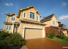 Fototapeta papr 160 x 116, 34945489 - Two new two-storied beige stone and brick cottage with garage