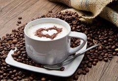 Fototapeta145 x 100  Coffee cup with burlap sack of roasted beans on rustic table, 145 x 100 cm