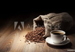 Fototapeta145 x 100  Coffee cup with burlap sack of roasted beans on rustic table, 145 x 100 cm