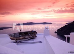 Fototapeta100 x 73  Santorini with boat on white roof against sunset in Greece, 100 x 73 cm