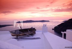 Samolepka flie 145 x 100, 41448704 - Santorini with boat on white roof against sunset in Greece