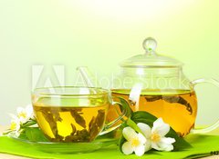 Fototapeta100 x 73  tea with jasmine in cup and teapot on table on green background, 100 x 73 cm