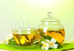 Fototapeta145 x 100  tea with jasmine in cup and teapot on table on green background, 145 x 100 cm