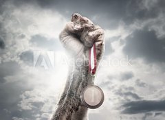 Fototapeta100 x 73  Male hand holding gold medal against the dramatic sky, 100 x 73 cm