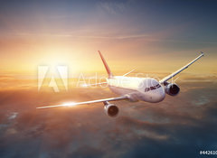 Fototapeta vliesov 100 x 73, 44261036 - Airplane in the sky at sunset - Letadlo na obloze pi zpadu slunce