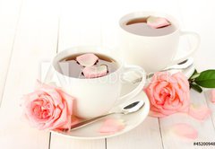 Fototapeta pltno 174 x 120, 45200948 - cups of tea with roses on white wooden table