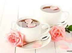 Fototapeta papr 360 x 266, 45200948 - cups of tea with roses on white wooden table