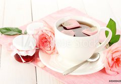 Fototapeta145 x 100  cup of tea with roses and jam on white wooden table, 145 x 100 cm