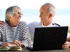 Fototapeta360 x 266  Senior couple in the garden with laptop and book, 360 x 266 cm