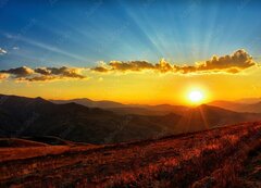 Fototapeta vliesov 200 x 144, 569569643 - Beautiful sun set with sweet clouds between mountains