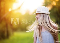 Fototapeta pltno 160 x 116, 76895650 - Beautiful woman outside in a park.