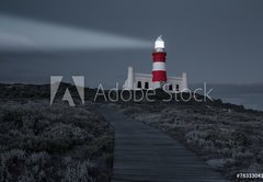 Fototapeta174 x 120  Lighthouse with shining light in darkness and dark blue clouds a, 174 x 120 cm