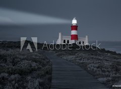 Fototapeta pltno 330 x 244, 78333041 - Lighthouse with shining light in darkness and dark blue clouds a - Majk se zcm svtlem ve tm a tmav modrmi oblaky a