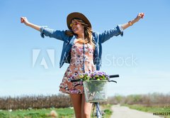 Fototapeta174 x 120  Beautiful young woman with a vintage bike in the field., 174 x 120 cm