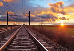 Fototapeta145 x 100  Orange sunset in low clouds over railroad, 145 x 100 cm