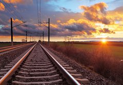 Fototapeta184 x 128  Orange sunset in low clouds over railroad, 184 x 128 cm