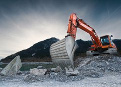 Fototapeta240 x 174  heavy organge excavator with shovel standing on hill with rocks, 240 x 174 cm