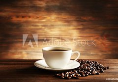 Fototapeta papr 184 x 128, 81865478 - Cup of coffee with grains on wooden background