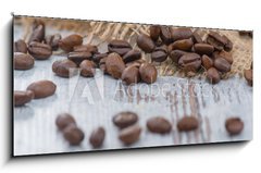 Obraz 1D panorama - 120 x 50 cm F_AB100905478 - Coffee beans lying on the table  - Kvov zrna lec na stole