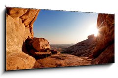 Obraz 1D panorama - 120 x 50 cm F_AB14081453 - Cave and sunset in the desert mountains