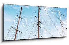 Sklenn obraz 1D panorama - 120 x 50 cm F_AB166856176 - Masts of sailboat and blue sky - Story plachetnice a modr oblohy