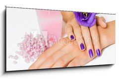 Obraz 1D panorama - 120 x 50 cm F_AB16907510 - Hands with purple manicure and flower, pink candle and beads