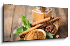 Sklenn obraz 1D panorama - 120 x 50 cm F_AB224205694 - Fresh cinnamon sticks and powder
