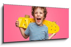 Skleněný obraz 1D - 120 x 50 cm F_AB245786759 - Happy curly boy laughing and holding skateboard - Šťastný kudrnatý chlapec se směje a drží skateboard