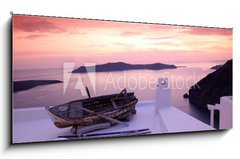 Obraz 1D panorama - 120 x 50 cm F_AB41448704 - Santorini with boat on white roof against sunset in Greece - Santorini s lod na bl stee proti zpadu slunce v ecku