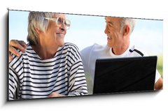 Obraz 1D - 120 x 50 cm F_AB46296780 - Senior couple in the garden with laptop and book