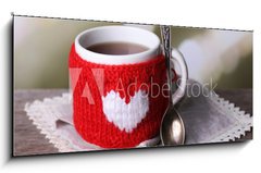 Obraz 1D panorama - 120 x 50 cm F_AB71618914 - Cup of tasty hot tea, on wooden table, on light background